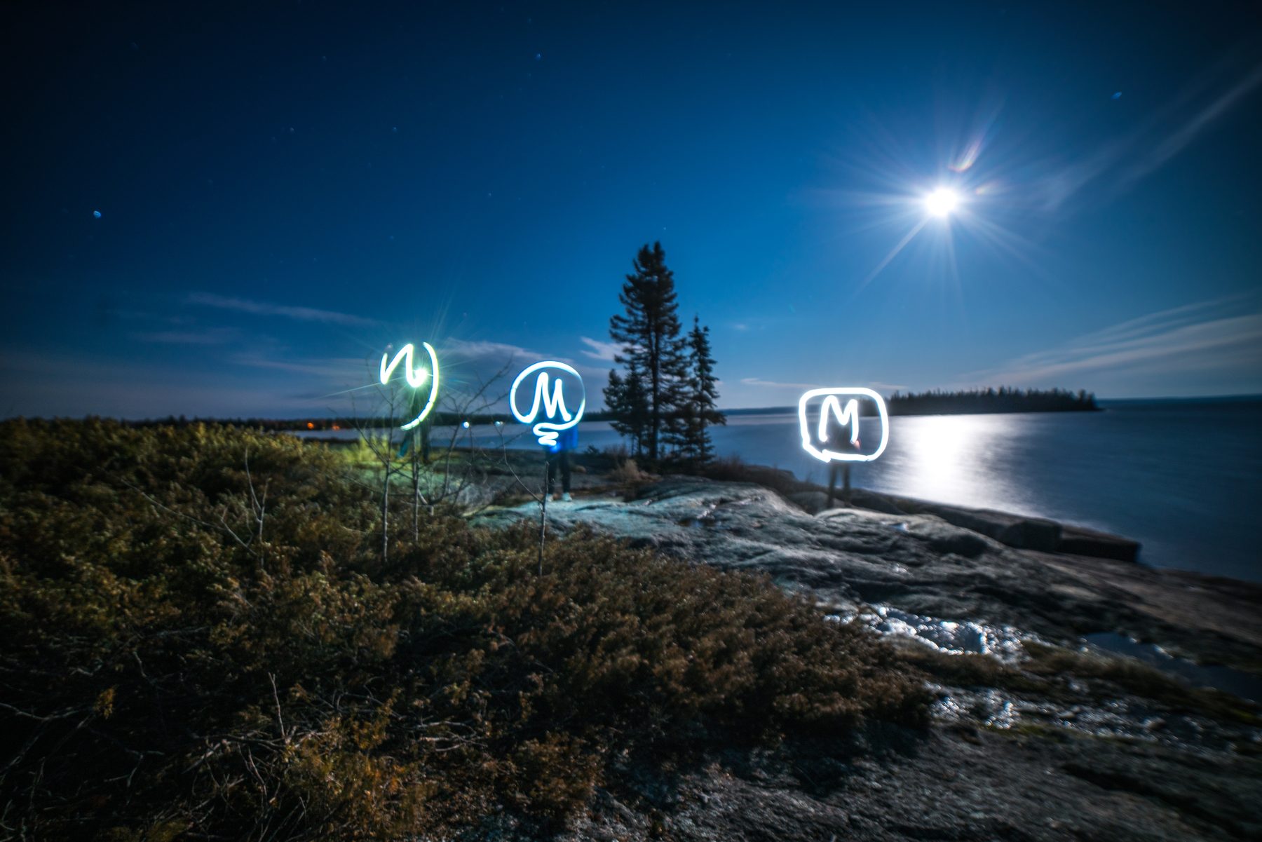 Initials light-painted onto a moonlit point