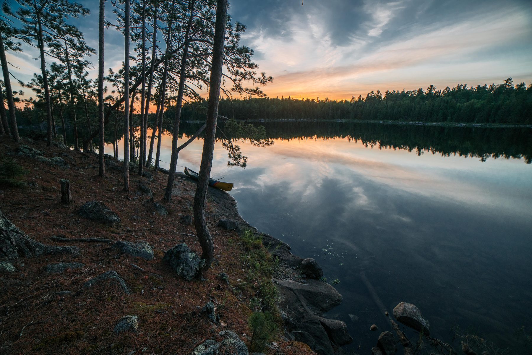 Last light at camp, canoe pulled up for the night