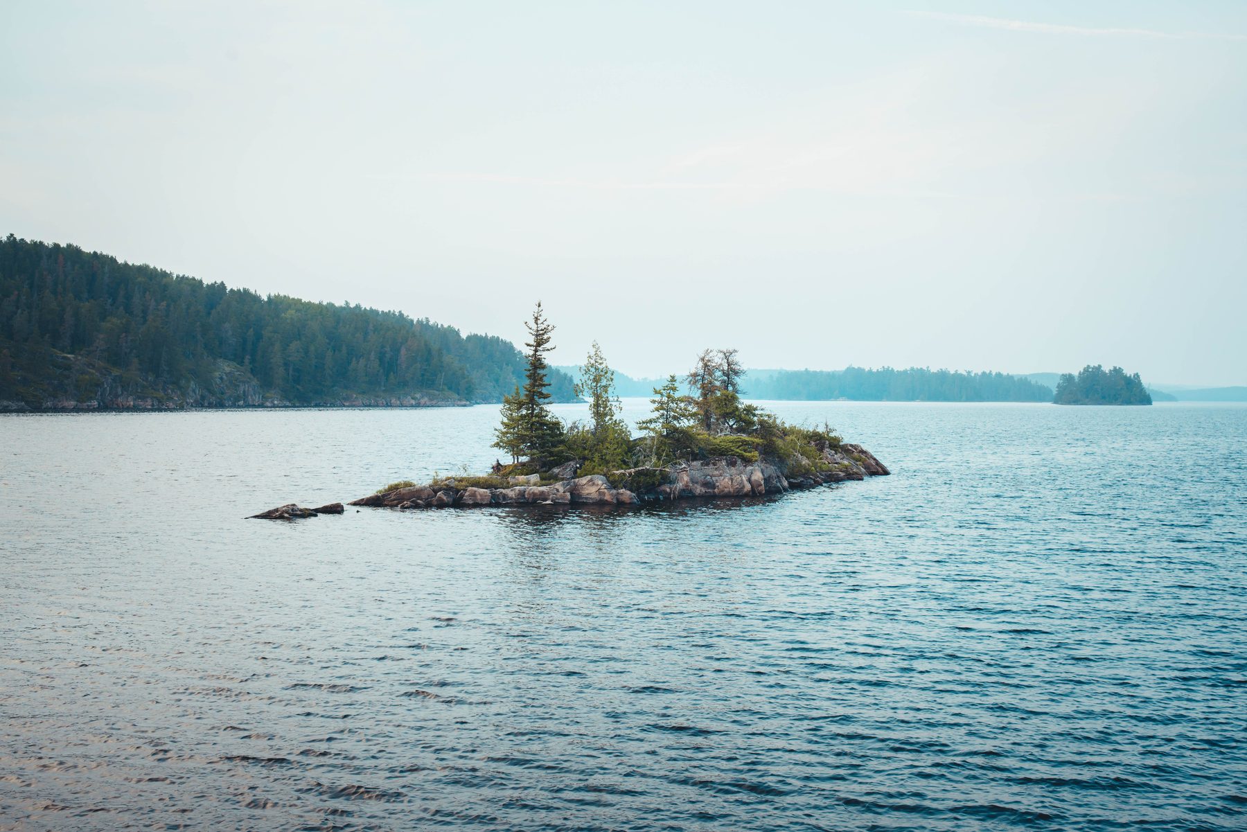 A rocky islet holds its few trees against the open lake